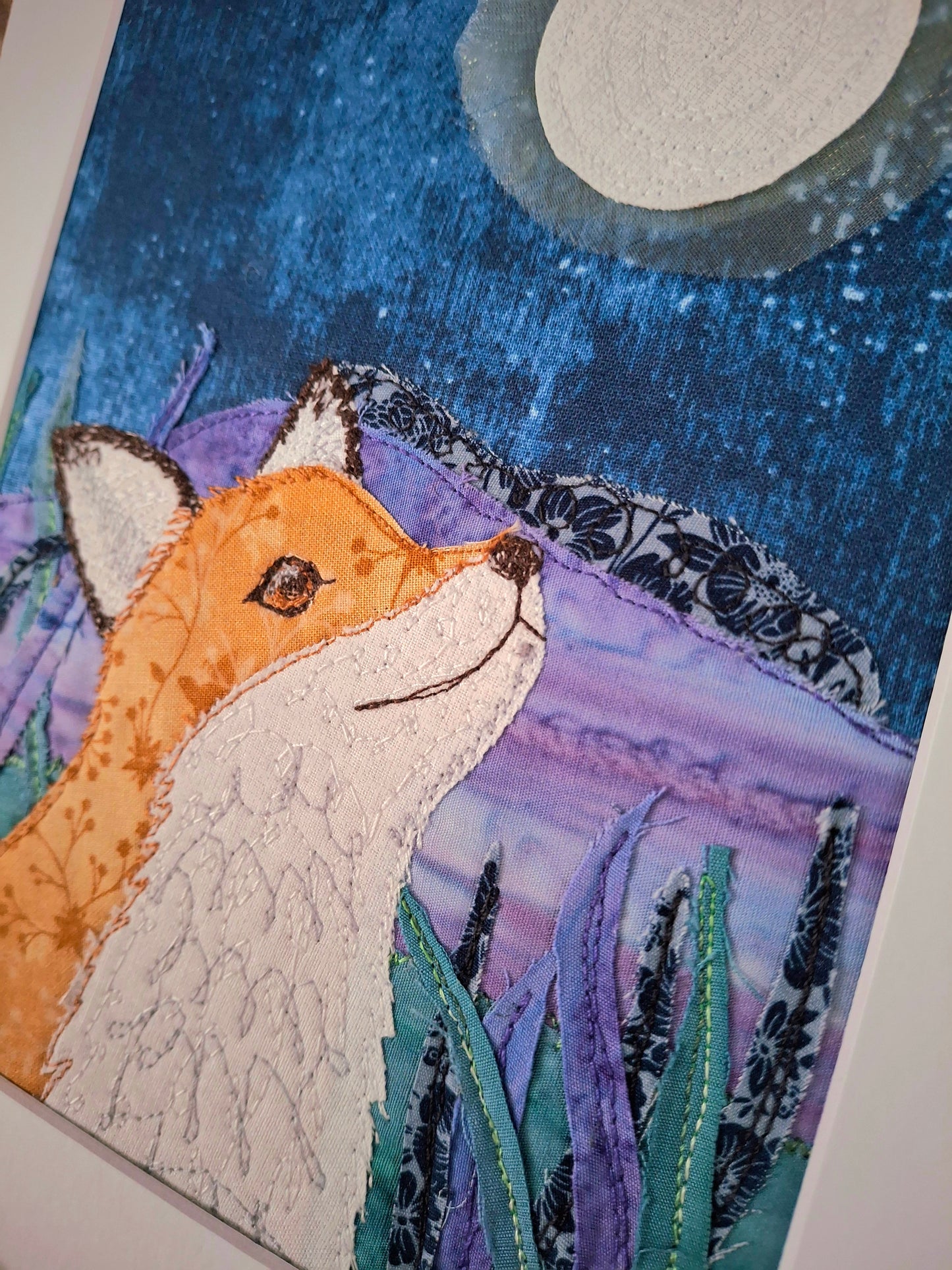 Artistic depiction of a fox in a natural setting with a moonlit sky.